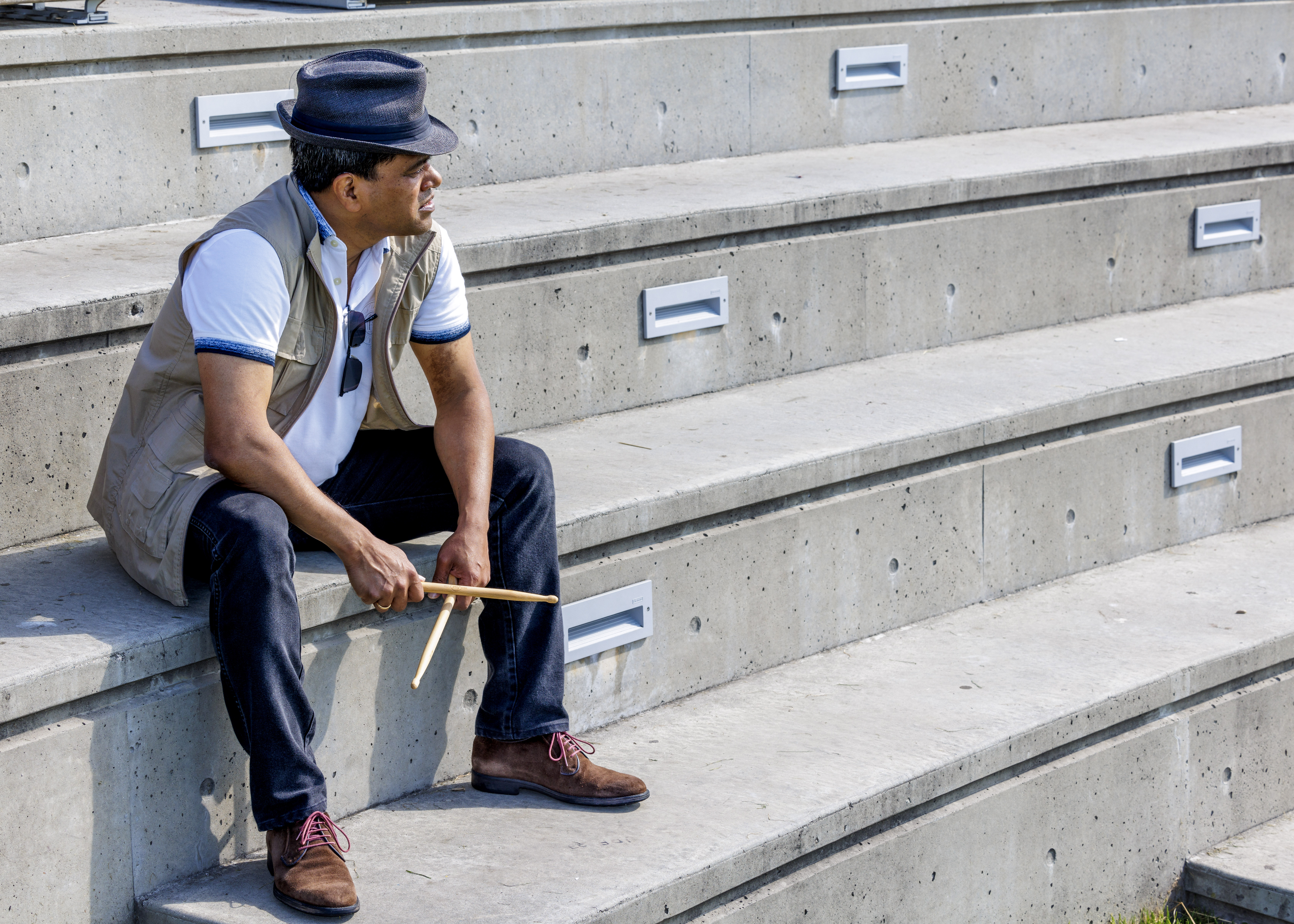 A neon stick figure appears to be dancing, with a graphical representation of sound waves emanating from its body, as if m...